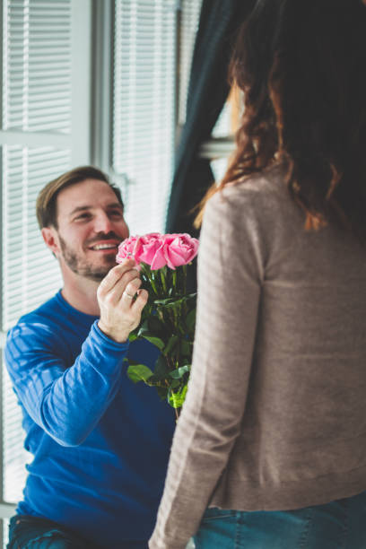 istock Man kneeling, holding ring in front of woman 1139737164