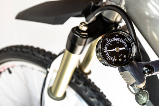 istock Pumping of the front, bicycle oil-air shock absorber using a specialized pump, visible pressure indicator in units of bar / psi. 1139738930