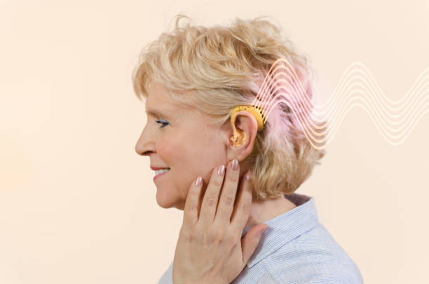 istock Side view senior woman with hearing aid 1139738993