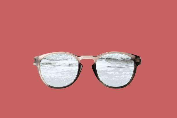 Fashionable glasses on a coral background