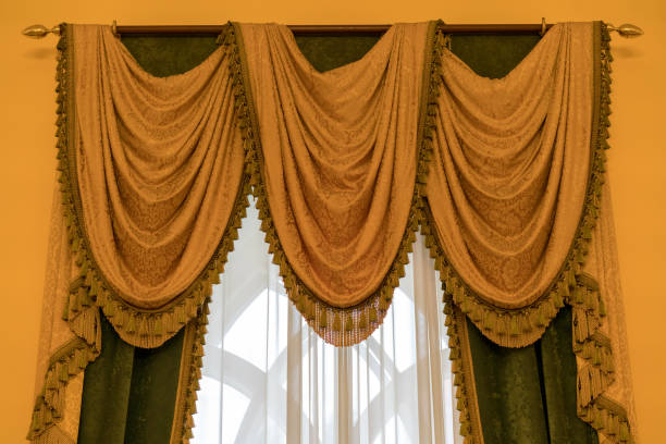 istock Classic beige curtain hanging on a window 1139740253