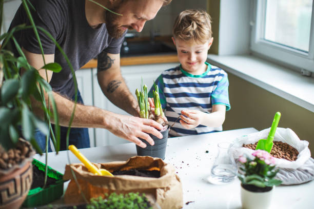 istock Father and son planting at home 1139740346