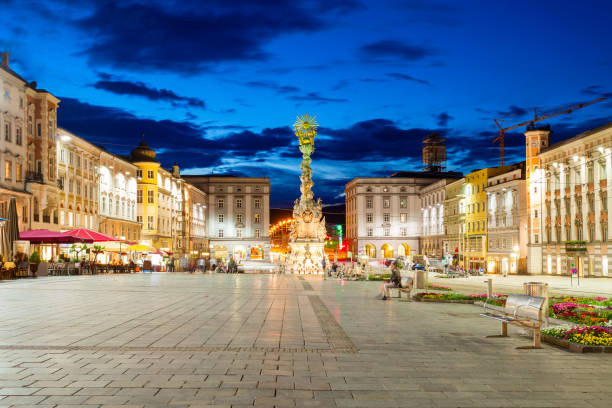 Main Square main square, Linz Holy Trinity column on the Hauptplatz or main square in the centre of Linz in Austria at sunset. Linz is the third largest city of Austria. linz austria stock pictures, royalty-free photos & images