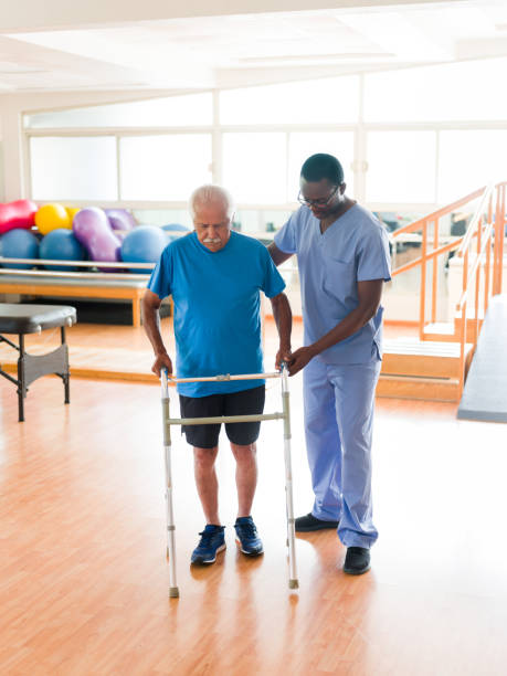 istock Male nurse helping senior man walk with walking frame 1139743426