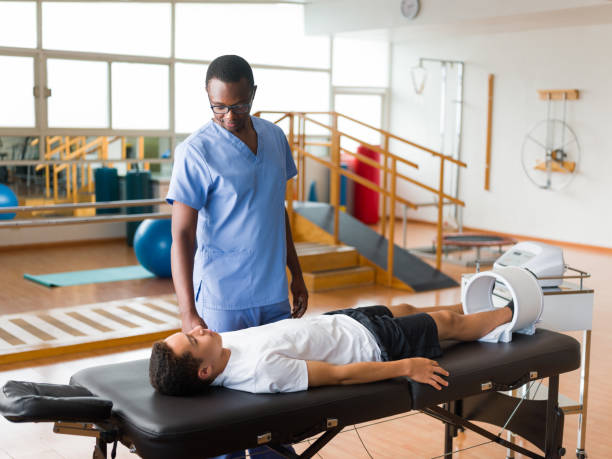 istock Teenage boy getting leg treatment with electronic device 1139743500