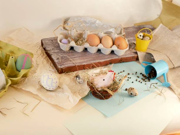 istock Chicken and quail eggs, toy chicken, hay, Easter decor on a light background 1139746725