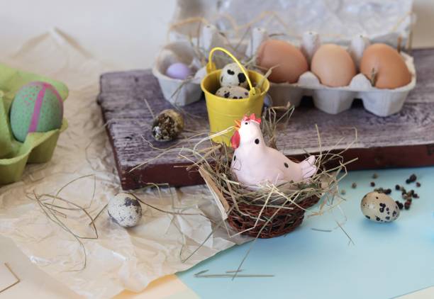 istock Chicken and quail eggs, toy chicken, hay, Easter decor on a light background 1139746758