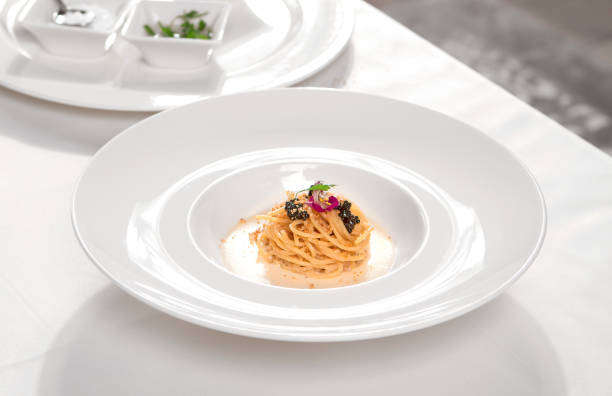 Italian pasta with black caviar and cream