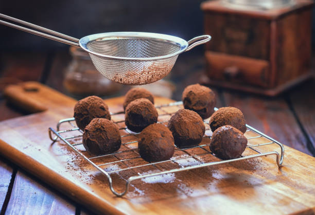 istock Young Woman Preparing Chocolate Truffles 1139753615
