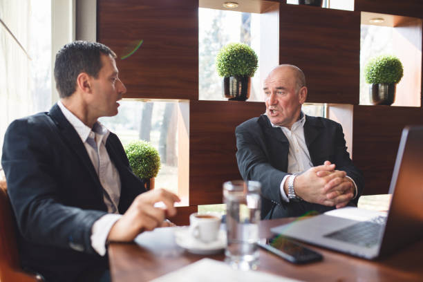 istock Senior men having a conversation with a cup of coffee 1139754384