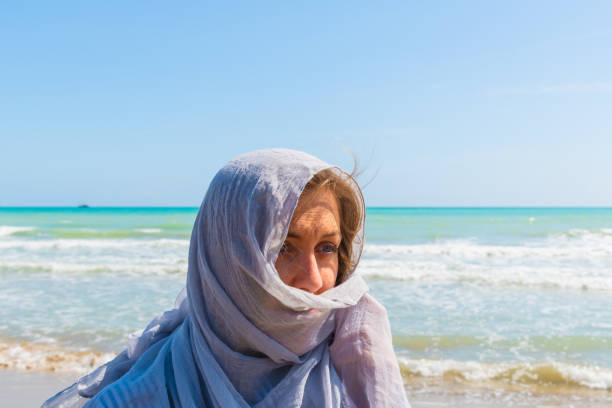 istock young women with light gray scarf 1139758326
