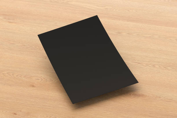 istock Blank black paper sheet flying over background 1139758914