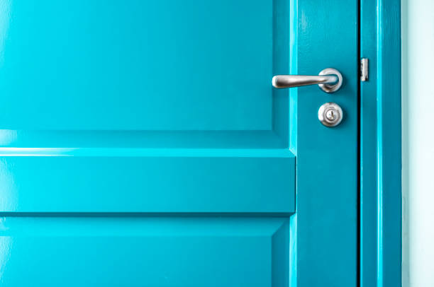 istock Closed solid wooden door is painted in bright blue with a beautiful metal handle and lock. 1139760037