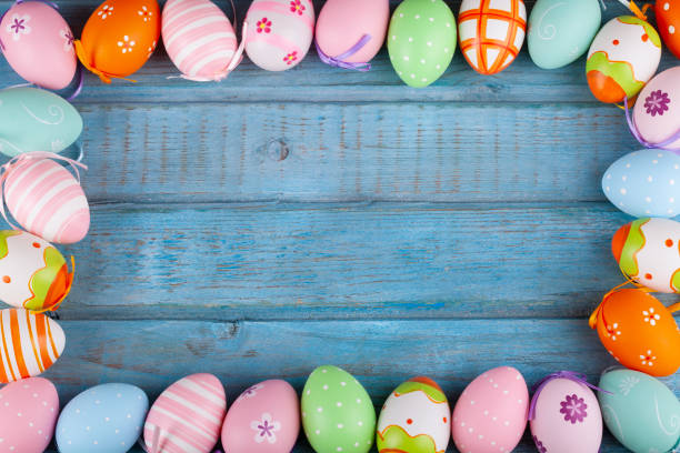 Colorful Easter eggs on turquoise rustic wooden table Colorful Easter eggs on turquoise rustic wooden table. revival stock pictures, royalty-free photos & images