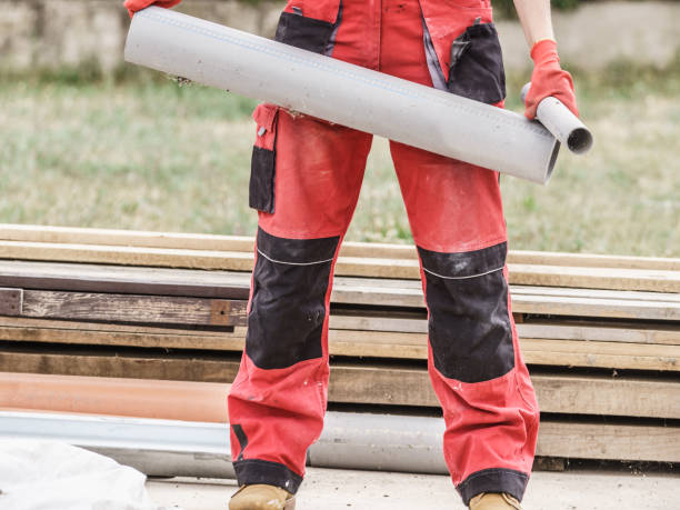 istock Woman carrying pipes on construction site 1139761863