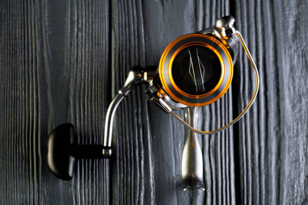 istock Fishing reel on wooden table 1139765539