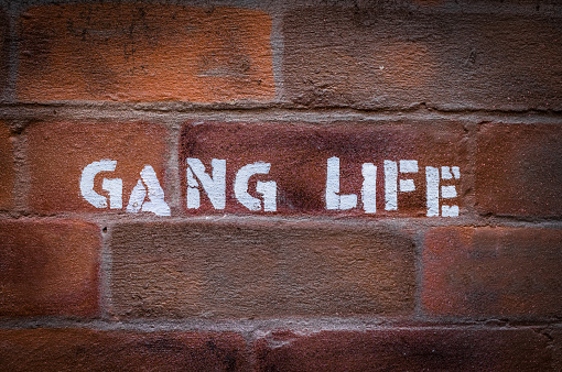 Urban Gang Life Stencil Graffiti On A Red Brick Wall