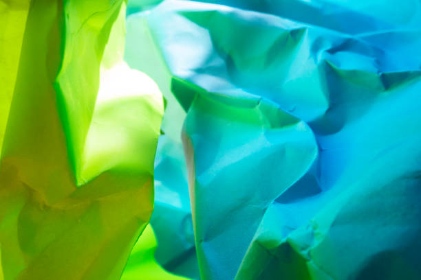 istock Wrinkled neon green and yellow papers background 1139769811