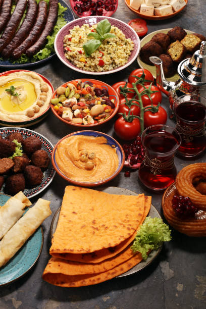 istock Middle eastern or arabic dishes and assorted meze, concrete rustic background. Falafel. Turkish Dessert Baklava with pistachio. Halal food. Lebanese cuisine 1139770698