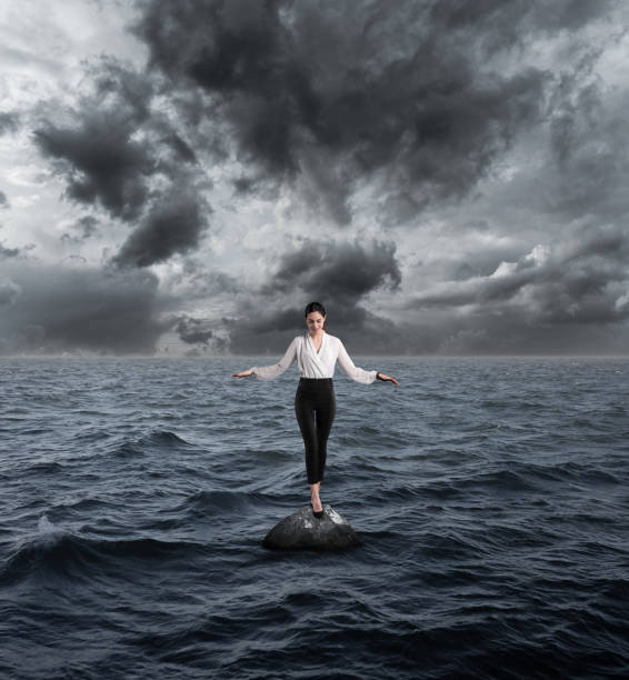 istock Businesswoman balancing on stone 1139774584