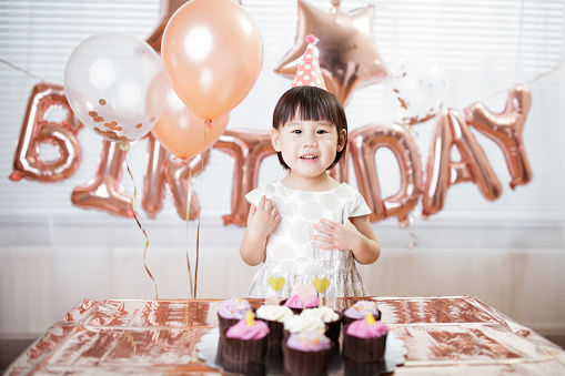 toddler girl celebrating her third birthday at home