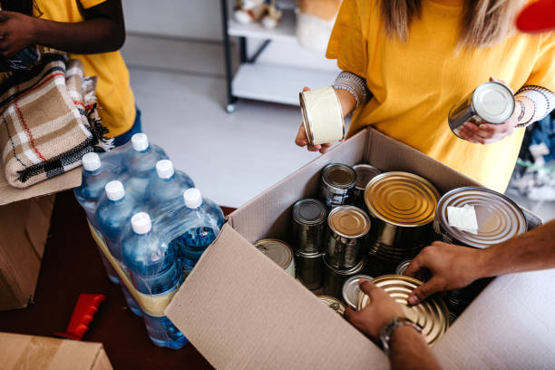 Generous people helping to poor people Small mixed race group of people working in charitable foundation food bank stock pictures, royalty-free photos & images