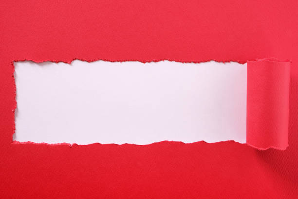 istock Torn red paper strip curled edge center frame white background 1139776978