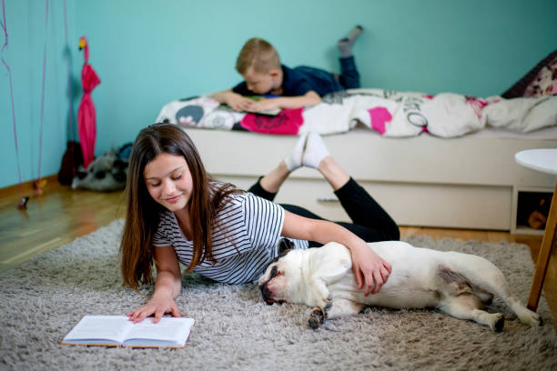 istock Cuddling her dog reading a book 1139782554