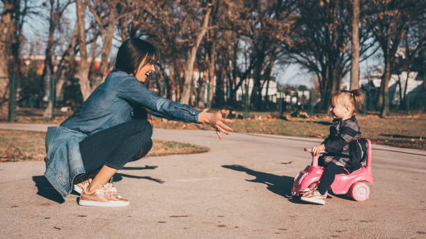 istock Young mom playing with her daughter in the park 1139784396