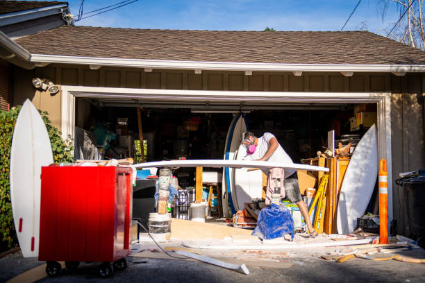 Young Entrepreneur Crafting A Custom Surfboard in Garage Studio