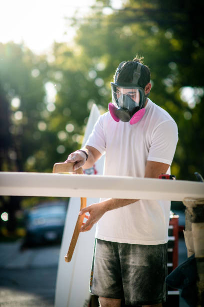 Young Entrepreneur Crafting A Custom Surfboard