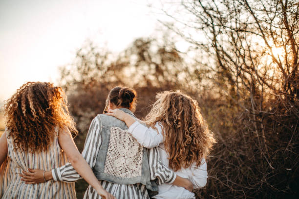 istock Best female friends blowing soap bubbles in nature 1139786437