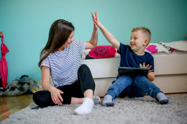 istock Older sister is helping younger brother to do homework 1139788612