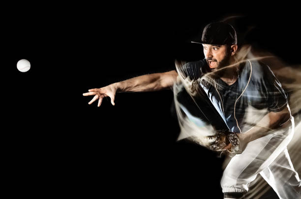 istock baseball player man isolated black background light painting 1139789419