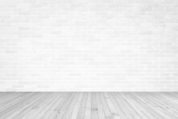 istock White brick wall with wooden floor textured background in light grey color 1139789499
