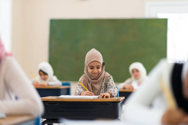 istock Smiling muslim girl writing 1139790240