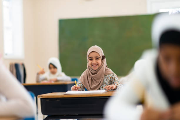 istock Smiling muslim girl writing 1139790243