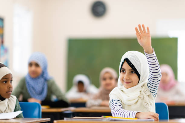 istock Muslim girl raising her hand 1139790281