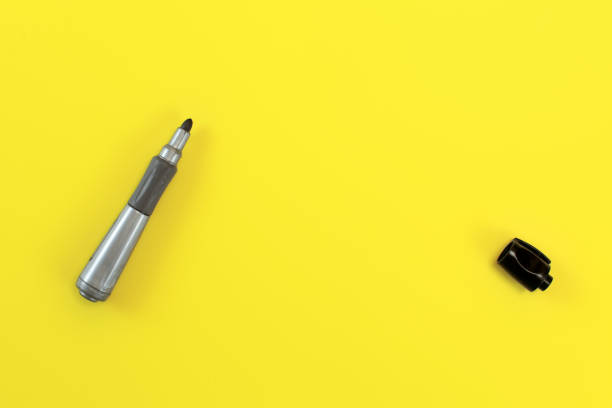 istock Thick black marker pen with opened cap on yellow board - space to write your text, view from above. 1139790349