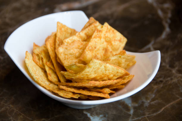 istock Chips, crisps with seasoning on white plate on the table 1139790451