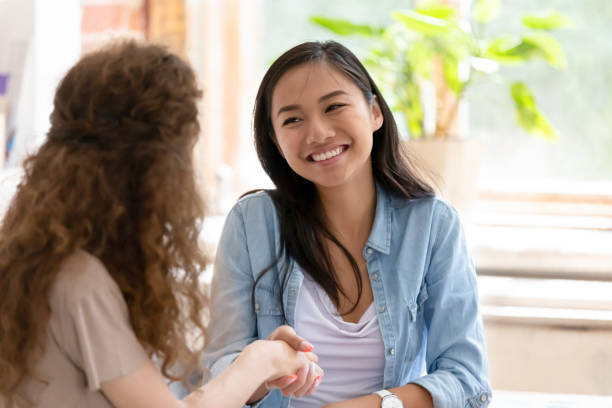 istock Young diverse friendly girls handshaking thanking for help in teamwork 1139791089