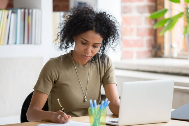 istock African woman worker or student working with laptop making notes 1139791227