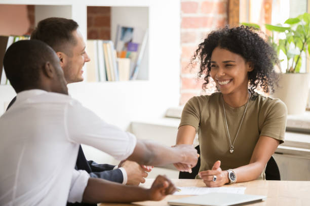 Happy female african vacancy candidate shaking hand of hr manager Happy female african vacancy candidate shaking hand of hr recruiting manager congratulating hired applicant with handshake, successful interview winner make good first impression got new job concept women satisfaction decisions cheerful stock pictures, royalty-free photos & images