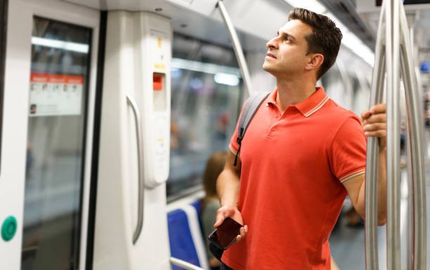 istock Man is standing in train and looking in the phone 1139792232