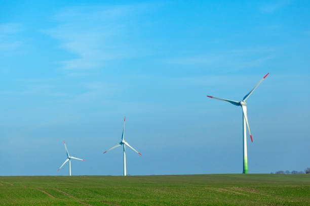istock wind generators in a field on a clear sunny day 1139792578
