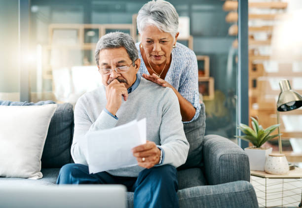There can be burdens to budgeting Shot of a mature couple looking worried while going through paperwork together at home financial item stock pictures, royalty-free photos & images