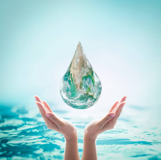 istock World ocean day, saving water, environmental protection, sustainable ecological ecosystems concept with green earth drop on woman's hands on sea background: Element of this image furnished by NASA (https://images.nasa.gov/details-PIA18033) 1139793009