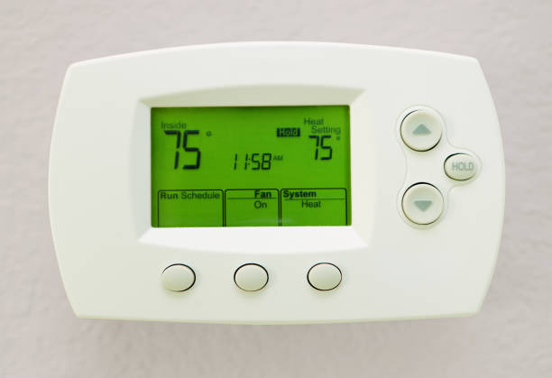 Programmable Digital Thermostat Showing 75 Degrees In Fahrenheit's stock photo