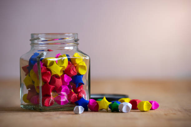 istock Multicolor paper star in square glass bottle. 1139795440