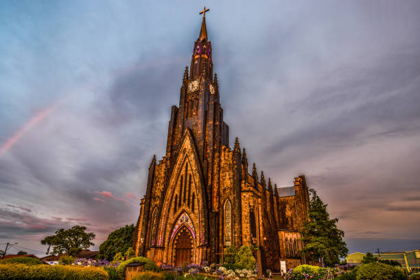 Photo of Cinnamon Cathedral and its beautiful garden on a sky day with rainbow.